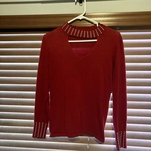 Red long sleeved sweater with silver studded detail